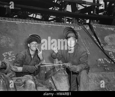 LIBERTY SHIPS  Two electric welders working on the Liberty class cargo ship USS Frederick Douglass in at the Bethlehem-Fairchild shipyards in Baltimore, Maryland by the Luckenbach Steamship Company in May 1943. She was sunk by U-boats on 20 September 1943 during an attack on convoy ON-202. Stock Photo