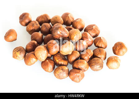 Delicacies hazelnuts scattered on the white background Stock Photo