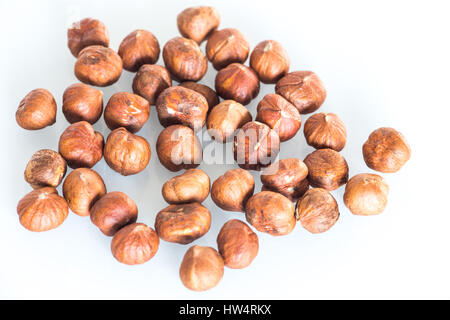 Delicacies hazelnuts scattered on the white background Stock Photo