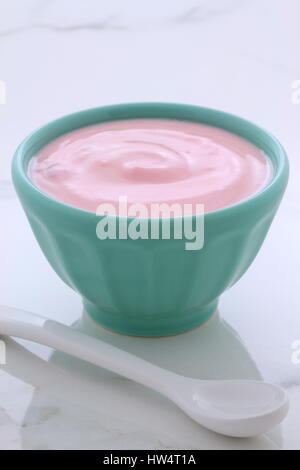 Delicious french custard-style yogurt with all the fruit mixed inside during the process. On vintage Italian carrara marble retro styling. Stock Photo