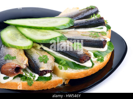 Sprats sandwiches, appetizer on plate isolated on white Stock Photo