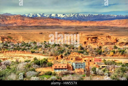 Snowy High Atlas Mountains above Kalaat M'Gouna town in Morocco Stock Photo