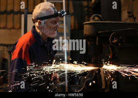 Somerset, Uk. Mechanical engineer David Andrews works on job repairing machinery for Somdor Engineering Stock Photo