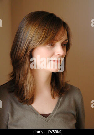 Head and shoulders of a pretty young woamn with shoulder length hair Stock Photo