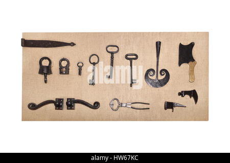 Vintage metal objects lying on the rough fabric, isolated on white Stock Photo