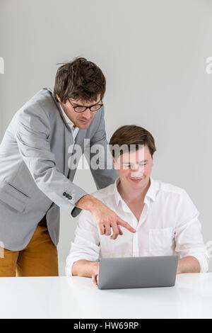 Portrait of smart businessmen discussing project in laptop at meeting Stock Photo