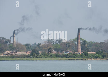 India, Kolkata (aka Calcutta until 2001) capital of the Indian state of West Bengal, located on the Hooghly River. Smoking chimney from a typical bric Stock Photo