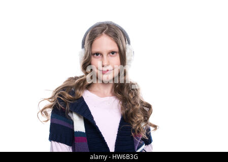 Pretty smiling little girl with curly hairstyle wearing colorful sweater and headdress isolated on white background. Winter clothes Stock Photo
