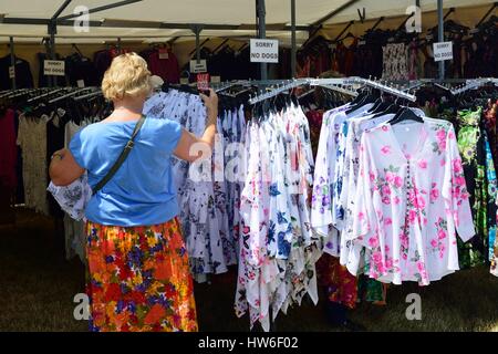 TENDRING SHOW ESSEX 11 JULY  2015: Dressses for sale on outdoor stall Stock Photo