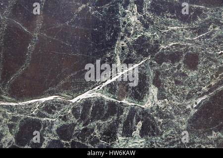 A background of old weathered black marble. Stock Photo