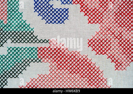 Detail of cross stitch embroidery. Abstract background in blue, red, green and pink threads. Stock Photo