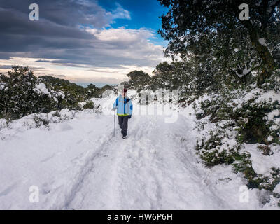 Hiker on snow covered footpath, Sierra de Mijas. Malaga province. Costa del Sol, Andalusia Southern Spain.Europe Stock Photo