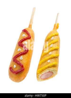 Corn dogs decorated with ketchup and mustard isolated on white background Stock Photo