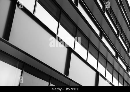 Modern industrial building facade abstract fragment, shiny windows in steel structure, black and white Stock Photo