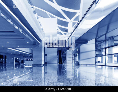 Spacious hall with escalators toned in blue color Stock Photo