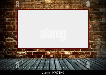 Illuminated blank advertising billboard on a brick wall Stock Photo
