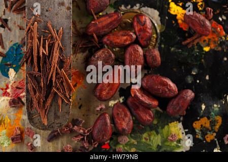 shredded chocolate and cocoa beans  on vintage painted background Stock Photo