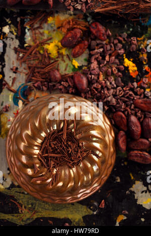 raw cacao nibs, shredded chocolate and cocoa beans  on vintage painted background Stock Photo