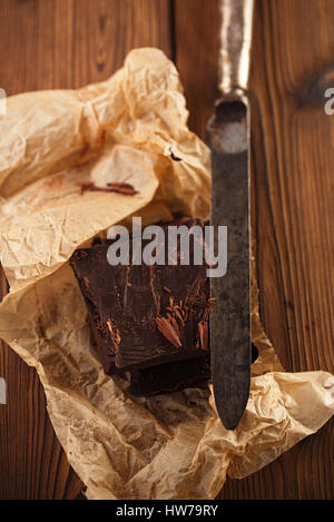 shredded chocolate on vintage spatula with paper and wooden background Stock Photo