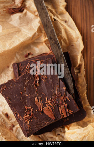 shredded chocolate on vintage spatula with paper and wooden background Stock Photo