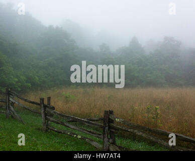 Foggy field and rail fence along Blue Ridge Parkway Stock Photo