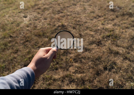 Hand hold magnifying glass,Searching concept,Business success research concept,Travel accessories Stock Photo