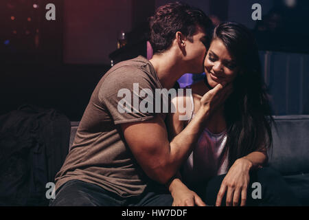 Romantic young couple at the night club. Young couple enjoying in the party at pub. Stock Photo