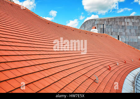 Tile roof with blue sky and clouds in background. Stock Photo