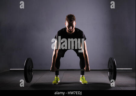 One handsom man lifting barbel. Crossfit fitness gym heavy weight bar by strong workout Stock Photo