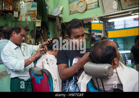 26.01.2017, Yangon, Republic of the Union of Myanmar, Asia - Two barbers are seen cutting the hair of clients in Yangon. Stock Photo