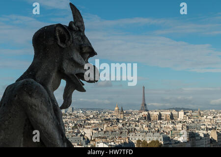 PARIS, FRANCE- OCTOBER 1, 2016:  A gargoyle on Notre Dame looks over the Eiffel Tower. Stock Photo