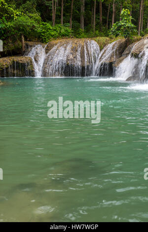 Secret single tier waterfall surrounded by deep rainforest jungle. Stock Photo