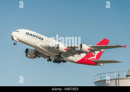A five hundred seat Qantas Airbus A380 departing into a crystal clear blue sky from Heathrow Airport, London, Stock Photo