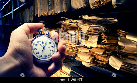 Hand holding stopwatch on budget numbers in closeup Stock Photo