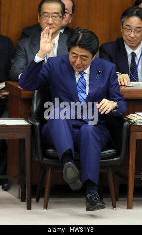 Tokyo, Japan. 17th Mar, 2017. Japanese Prime Minister Shinzo Abe raises his hand to answer a question by an opposition lawmaker at the Lower House's foreign affairs committee session at the National Diet in Tokyo on Friday, March 17, 2017. Abe is now center in a land deal scandal of a Osaka elementary school as he donated to the school operator Yasunori Kagoike, news reported. Credit: Yoshio Tsunoda/AFLO/Alamy Live News