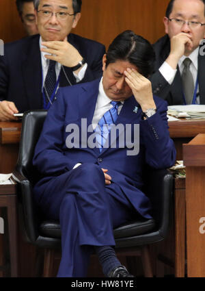 Tokyo, Japan. 17th Mar, 2017. Japanese Prime Minister Shinzo Abe listens to a question by an opposition lawmaker at the Lower House's foreign affairs committee session at the National Diet in Tokyo on Friday, March 17, 2017. Abe is now center in a land deal scandal of a Osaka elementary school as he donated to the school operator Yasunori Kagoike, news reported. Credit: Yoshio Tsunoda/AFLO/Alamy Live News