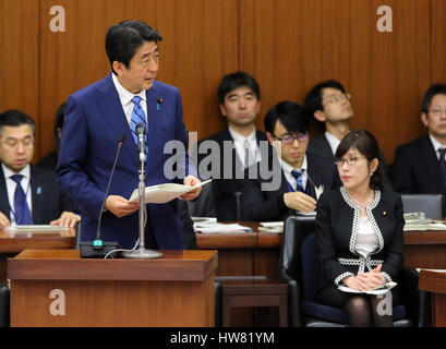 Tokyo, Japan. 17th Mar, 2017. Japanese Prime Minister Shinzo Abe answers a question by an opposition lawmaker at the Lower House's foreign affairs committee session at the National Diet in Tokyo on Friday, March 17, 2017, while Defense Minister Tomomi Inada (R) looks on. Abe is now center in a land deal scandal of a Osaka elementary school as he donated to the school operator Yasunori Kagoike, news reported. Credit: Yoshio Tsunoda/AFLO/Alamy Live News