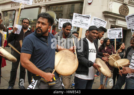 London, UK. March 18, 2017: Indian immigrants drum and chant as they prepare to participate in the Stand Up To Racism demonstration on UN Anti-Racism Day in the streets of London on March 18, 2017. The march began at Portland Place (BBC) and ended at Parliament Square, where a rally is scheduled. The UN Anti-Racism Day is a global day of action against racism in all its forms. © David Mbiyu/Alamy Live News Stock Photo
