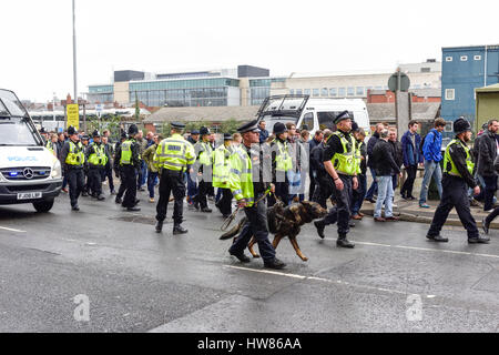 Nottingham, UK. 18th Mar, 2017. Heavy rain and cooler temperatures in the centre of Nottingham this afternoon, shoppers run for cover. Derby county fans escorted to city ground ahead of game with Nottingham forest Credit: Ian Francis/Alamy Live News Stock Photo