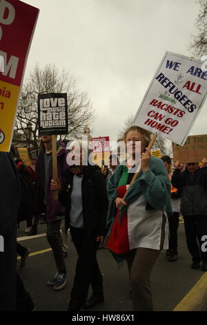 London, UK, 18th March 2017.Two women hold up placards as campaign group Stand Up to Racism holds a march through central London to mark UN anti-racism day. Roland Ravenhill/ Alamy Live News Stock Photo