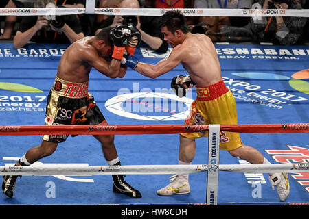 New York, New York, USA. 18th Mar, 2017. ROMAN ''CHOCOLATITO'' GONZALEZ and SRISAKET SOR RUNGVISA (gold and red trunks) battle in a super flyweight world championship bout at Madison Square Garden in New York. Credit: Joel Plummer/ZUMA Wire/Alamy Live News Stock Photo