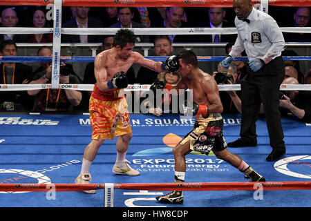 New York, New York, USA. 18th Mar, 2017. ROMAN ''CHOCOLATITO'' GONZALEZ and SRISAKET SOR RUNGVISA (gold and red trunks) battle in a super flyweight world championship bout at Madison Square Garden in New York. Credit: Joel Plummer/ZUMA Wire/Alamy Live News Stock Photo