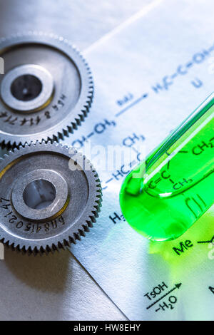 Chemicals tube with reaction formula and mechanical ratchets Stock Photo