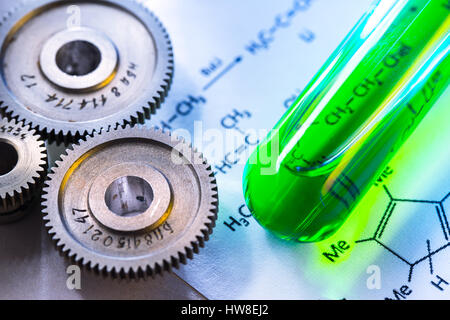 Chemicals tube with reaction formula and mechanical ratchets Stock Photo