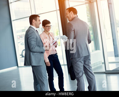 Business people having casual meeting in hall Stock Photo