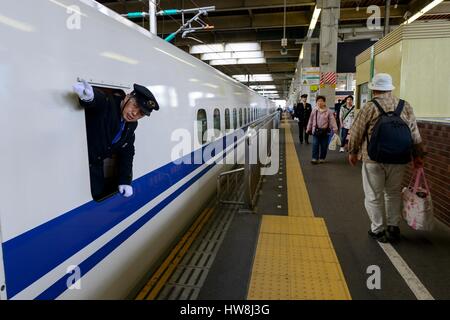 Japan, Honshu island, Hiroshima, Train assistent observes the Shinkansen's stop at Hiroshima station Stock Photo