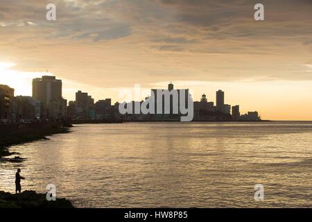 Cuba, Ciudad de la Habana province, Havana, fisherman on the Malecon and Vedado district in the background Stock Photo