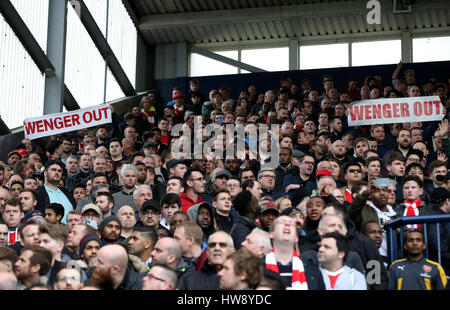 Fans hold up a Wenger Out banners in the stands during the Premier League match at The Hawthorns, West Bromwich. Stock Photo