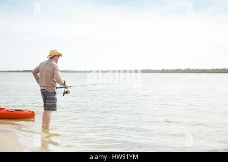 Fisherman in a kayak and a fishing rod with an old shoe on the hook  isolated on white background Stock Photo - Alamy