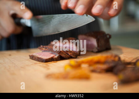 Roast beef on cutting board Stock Photo